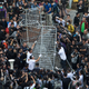 Building employees dismantle a barricade outside Citic Tower in accordance with a court injunction to clear up part of the protest site.